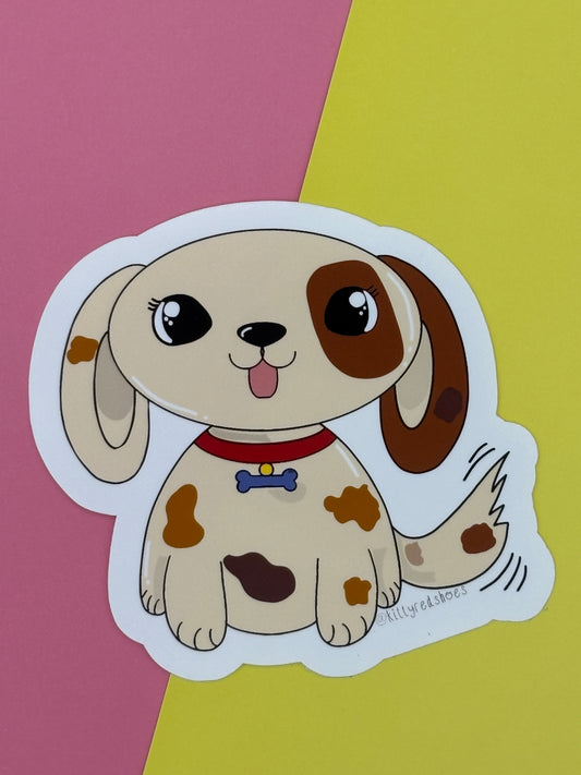 A sticker of a cute cartoon dog with a brown patch over one eye, other patches on its body and a wagging tail. 