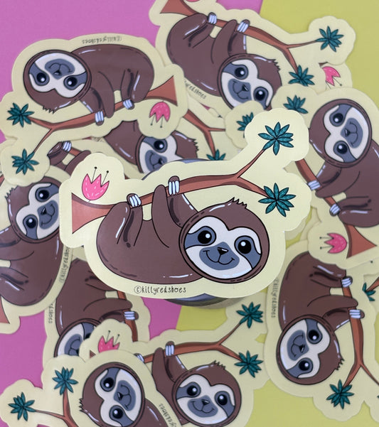 A sticker of a smiling brown sloth hanging from a tree branch on a yellow background resting on many of the same stickers.